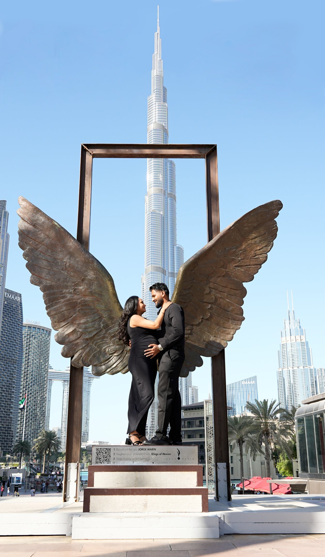 Couple maternity photoshoot – Husband and wife embracing at Wings of Mexico Dubai