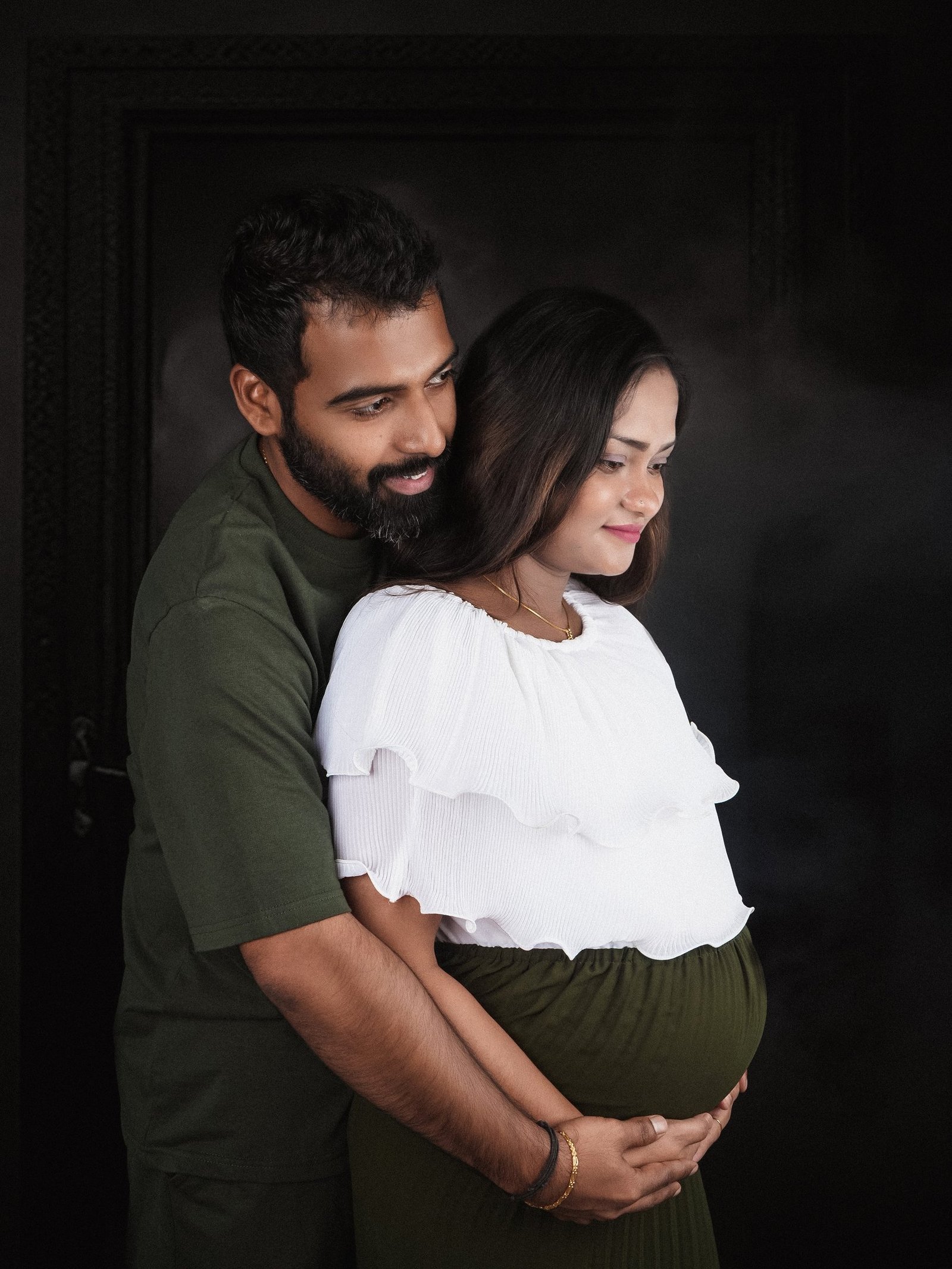 Couple maternity photoshoot – Husband and wife embracing at Pixel Craft Studio, Dubai