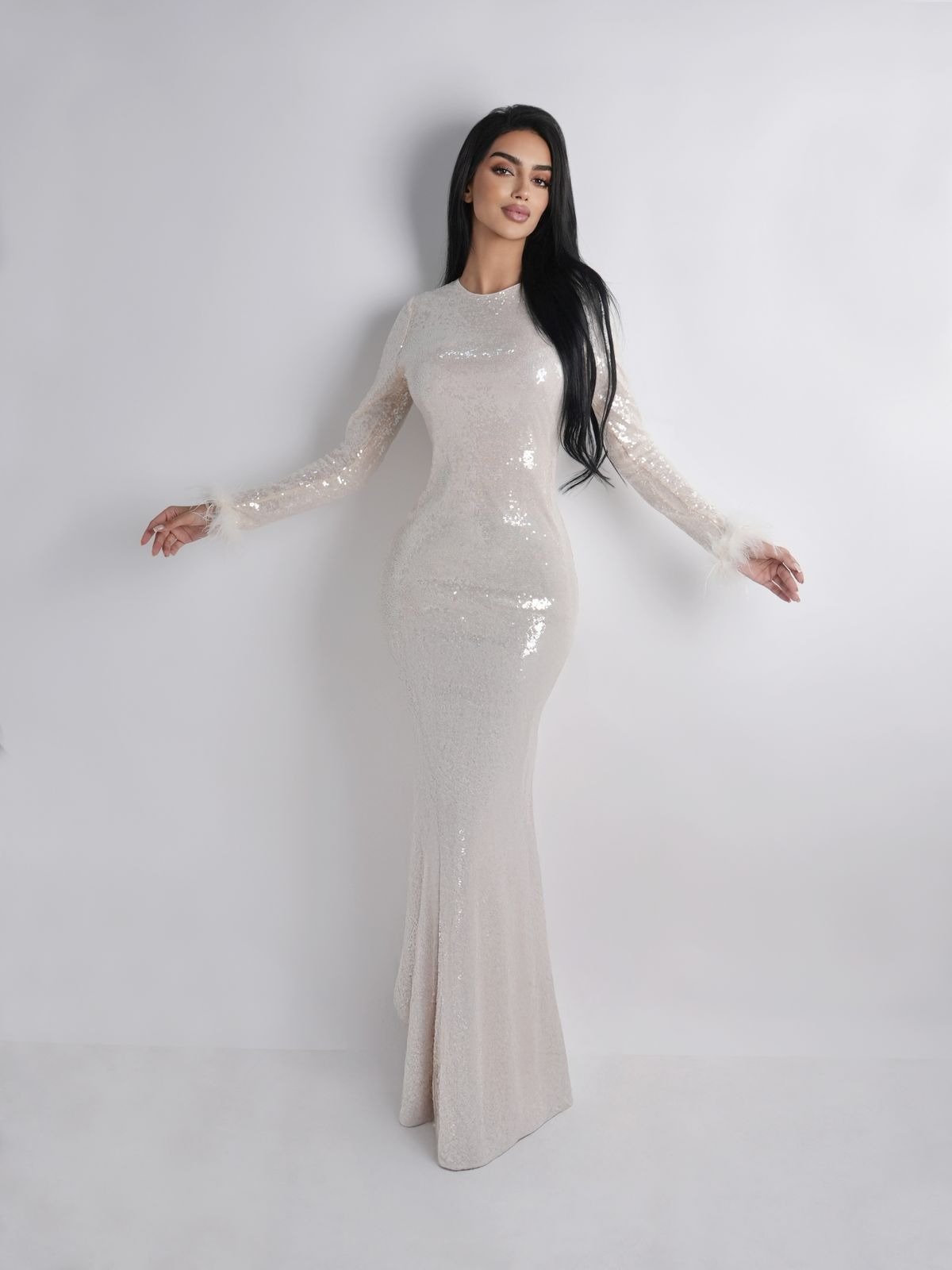 Dynamic standing pose showcasing personality and style, framed in a modern studio setting.